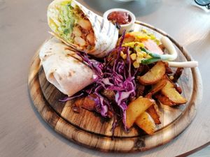 Burrito with potato wedges at Kozy Eats  in Riga