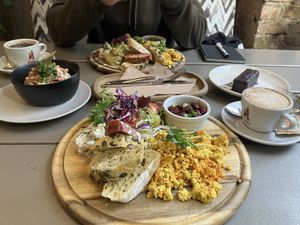 Kozy breakfast with Tofu scramble, salad, cottage cheese, bread and beans. Rasols salad to the left, snickers cake to the right.  at Kozy Eats  in Riga