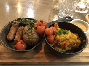 Oven baked potato with Beyond meat sausage and stewed cabbage   at Kozy Eats  in Riga