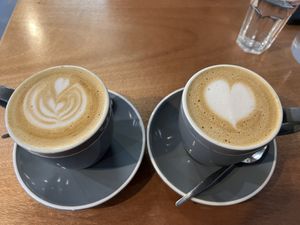 Lattes with nice free pour art  at Dramanti Artisan Roaster in Wynnum