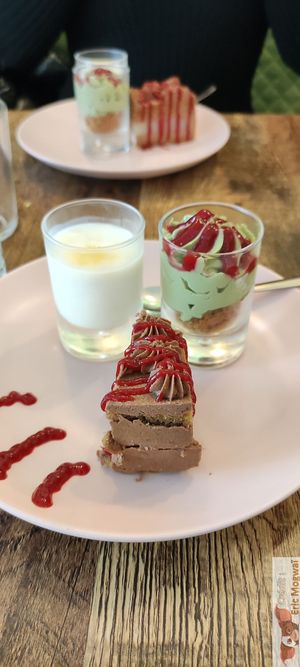 A dessert mignardise, with lemon and macha entremets and chocolate cake at Maison Sukoon in Paris