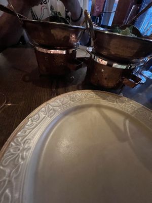 The food is served on top of a hot flame/candle   at Mantra in Oslo