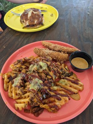 Loaded fries and fried pickles. How High bbq jackfruit sandwich in the background. at Twisted Plants in Cudahy