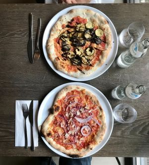 Eggplant pizza and a bolognese pizza. Both delicious. at Mama Earth in Salzburg