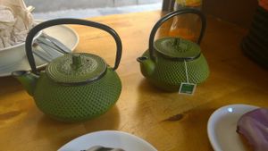 Green teas served in individual iron teapots( as a mealdeal with a donut) at Gopal - Vegan Deli in Barcelona