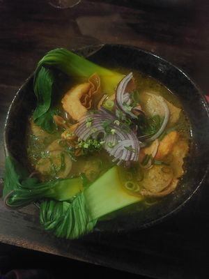nr.15 kurkuma noodle soup with dumplings, pak choi, soy strips,  shrimps, shiitake mushrooms at Ong Tao Vegan in Frankfurt