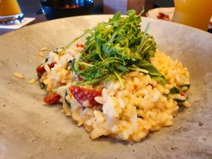 Leaf spinach risotto with dried tomatoes and rocket (vegan) at Unikat in Cuxhaven