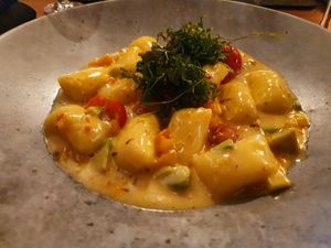 Gnocchi with cherry tomatoes, avocado, pumpkin and fried rocket (vegan) at Unikat in Cuxhaven