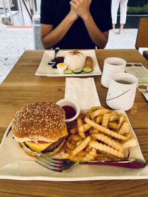 In front is the Beyond burger while in the back is the Nasi Lemak at Happy Veggie Restaurant in New York City