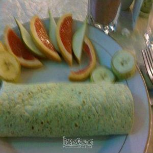 We Need Another Investor Burrito with a side of fruit at Peaceful Greens in Lafayette