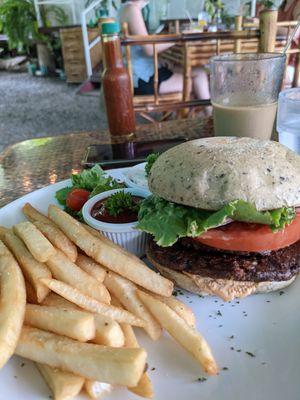 The la montaña burger with olive/rosemary bun. The garlic sauce was amazing as a dip for our fries. at Indómitos Café & Bar in Uvita