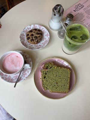 Pink babychino, choc chip cookie, pistatio cake and an iced matcha! 💚🩷 heaven   at OM NOM NOM CAFÉ in Munich