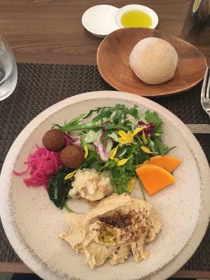 Hummus with salad and 3 deli items.  at PEACE TABLE - 渋谷 道玄坂店 in Tokyo
