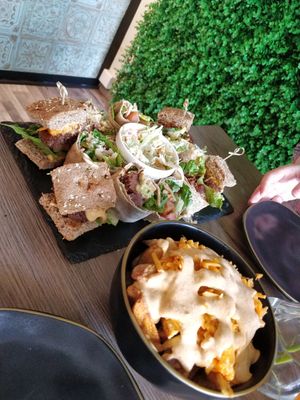 Platter of different sliders, coleslaw, and "cheesey" chips. at Elysian Restaurant in Nicosia