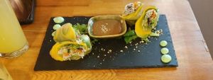 Vegan avocado and mango summer rolls with salad leaves, peanut sauce and vegan green mayo dots.  at Be Right Back in Linz