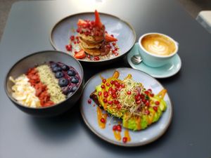 Superfood açaí bowl, Rootella pancakes, avocado toast, flat white with oat milk at Roots - Maschinenstraße in Zurich