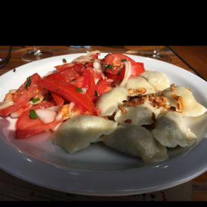 lentil pierogi with tomato salad  at Glonojad in Krakow