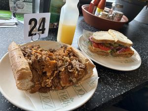 Breakfast Philly Cheesesteak and a vegan sandwich with a pineapple juice (I think)   at Nourish Philly in Philadelphia