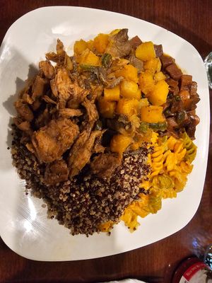 Divine platter: Quinoa, Mac n Cheese, jerk beef, mushrooms & butternut squash, and vegan oxtail. at Nourish Philly in Philadelphia