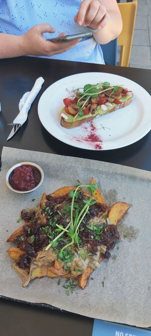 Vegetarian baked potato dish with mushrooms and cranberries and in the back vegan avocado sandwich. at IBA.TU Bistro in Vysoke Tatry