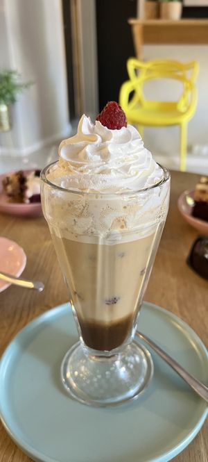 Ice coffee with vegan whip cream and raspberries  at AleBabeczka Kawiarnia in Kielce