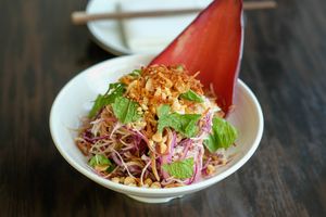 Chick'n Blosson Salad - King oyster mushroom, banana blossom, rau ram, cabbage, herbs, pickles, crispy shallot, peanuts, vinaigrette, crispy rice paper at Chi in Vancouver