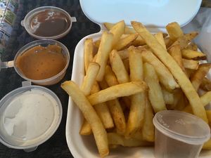 Fries with three choices of vegan sauces at The Dead Pigeon in Rochester