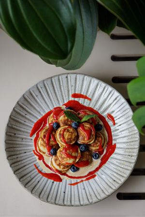 Pancakes with peanut butter sauce and strawberry couli at Commune Cafe in Tallinn