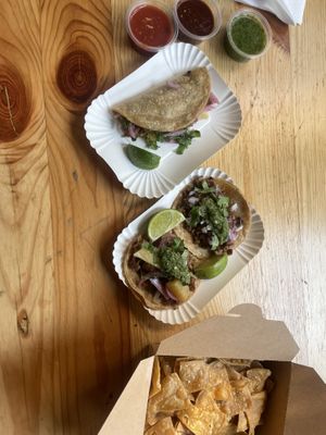 Vegan quesabirria (top) and al pastor and carnitas tacos, plus three salsa. He’ll tell you the spicy is SUPER spicy, but it’s medium-hot.  at Taco Love in Berlin