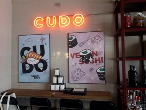 Interior with funky posters and nice neon at Cudo Vegan Sushi in Poznan