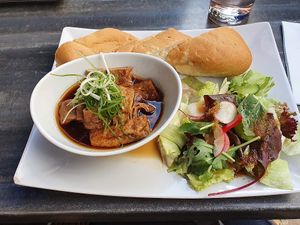 Vietnamese Goulash with salad and baguette at Vevi in Vienna
