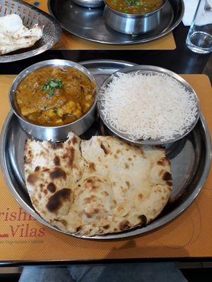 Spicy curry with potato and cauliflower, served with rice, naan ordered seperately at Krishna Vilas in Eindhoven