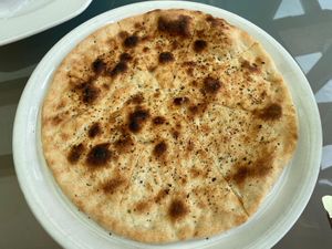 Focaccia Rotonda - white pizza with olive oil, sea salt and oregano at San Marco Da Claudio in Garmisch-partenkirchen