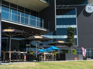 Umbrellas and tables outside Raw Energy Springfield at Claire's Wholesome Kitchen in Springfield Central
