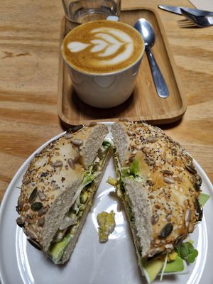 Flat white and bagel at NEØ Coffee House in Barcelona