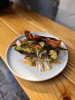 Avocado Toast with vegan bacon and cucumber kimchi at NEØ Coffee House in Barcelona