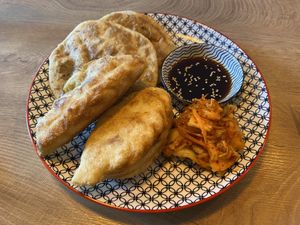 Mongolian dumplings above, Russian ones below, kimchi  at Veganaa in Berlin