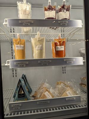 Deli case packaged cheeses and sauces at Planticeria in Panama City