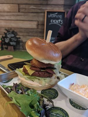 Vegan burger with salad, cheese, this isn't bacon, and onion rings. Served with fries and coleslaw. at Timmy's Bar & Kitchen in Carlisle