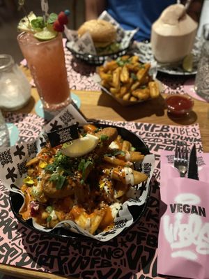 Vegan Cod, XL Cajun fries, Mc Cruelty Free burger, Holy Dragon and Vatos Cocos cocktail  at Vegan Junk Food Bar - El Born in Barcelona
