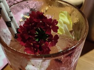 Delicious cocktail with flowers at Vegan Junk Food Bar - El Born in Barcelona