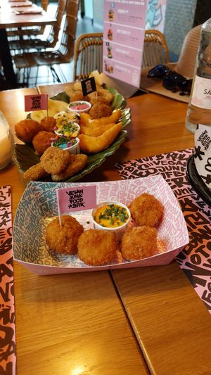Kroquette and fish platter in the back. at Vegan Junk Food Bar - El Born in Barcelona