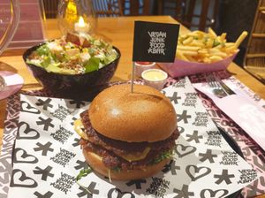 Double classic burger, side salad, and fries at Vegan Junk Food Bar - El Born in Barcelona