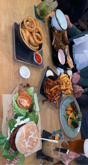Beetroot burger with vegan greek cheese and a hemp sauce. Onion rings with chilisauce and sweet potato and regular fries with vegan mayonnaisse and truffle mayonnaise 🥰 at De Buurman in Heerenveen