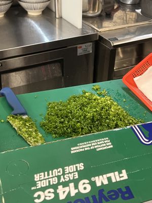 Chopping green onions fresh in store   at Soulmate Ramen 素味謀麵 in Hong Kong Island