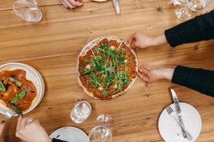 Oven-baked pizza with charred capsicum sauce and pieces, roasted pumpkin, capers, rocket, pesto, housemade ‘feta’ and chilli oil at Mother in Fremantle