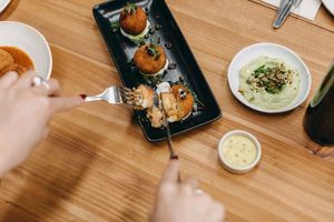 Sun-dried tomato and ‘mozzarella’ arancini balls with ‘aioli’, pesto, olives and capers at Mother in Fremantle