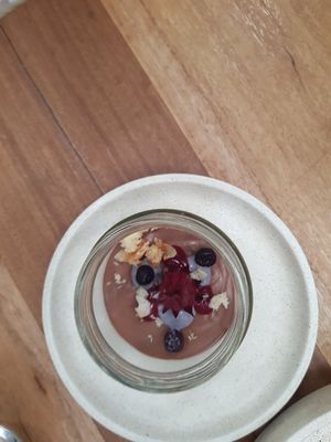 Vegan chocolate mousse w blueberry raspberry and edible flower (GF and processed sugar free) at Mother in Fremantle