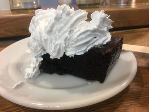 Brownie with whipped cream  at Vx in North London