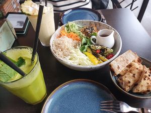 Detox juice, Pina colada smoothie, vegan bowl, bread on the side at Juicy Skagen in Skagen